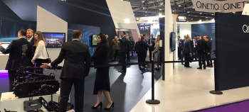 QinetiQ DSEI stand showing tracked robot drone being shown to a guest by stand personnel