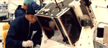 Technician working on a satellite