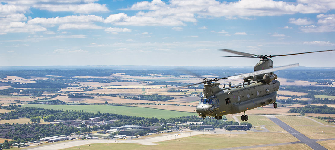 Chinook in flight over fields