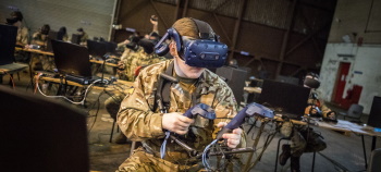 Soldier using VR headset and controllers