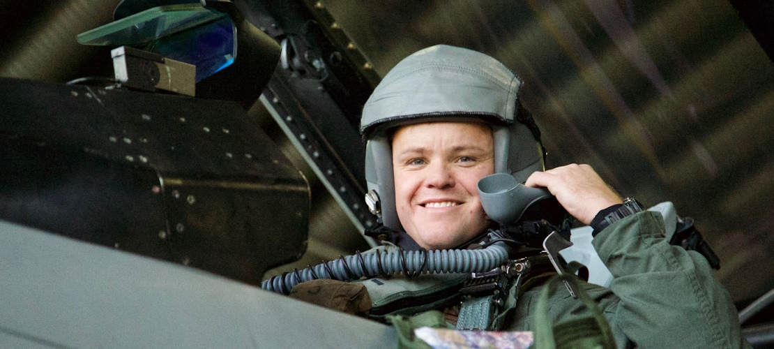 Pilot smiling from the cockpit of an aircraft