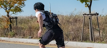 Man running whilst wearing the exoskeleton