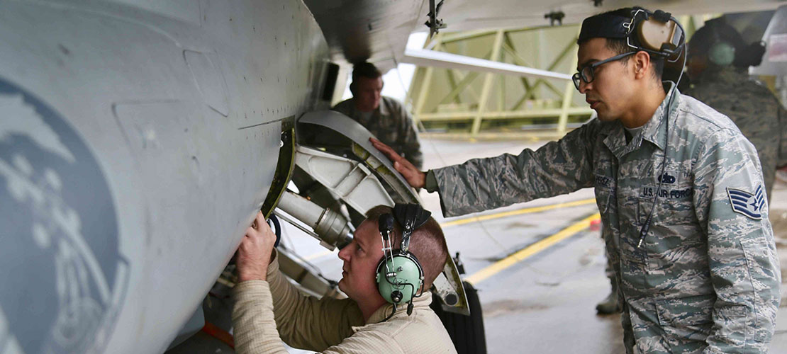2 aircraft engineers working on an aircraft