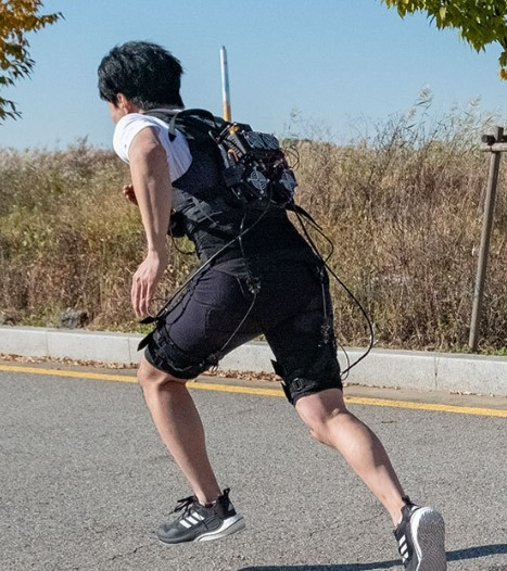 Man running whilst wearing the exoskeleton